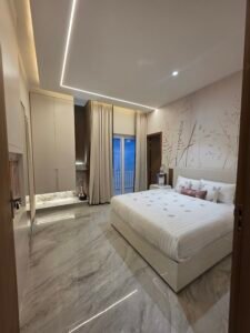 About “Modern 3BHK bedroom at Hare Krishna Ashiyana near Prem Mandir offering comfort and spiritual vibes”