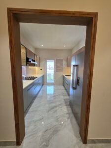About “Modern modular kitchen at Hare Krishna Ashiyana in Vrindavan with stylish cabinets, ample storage, and premium finishes”